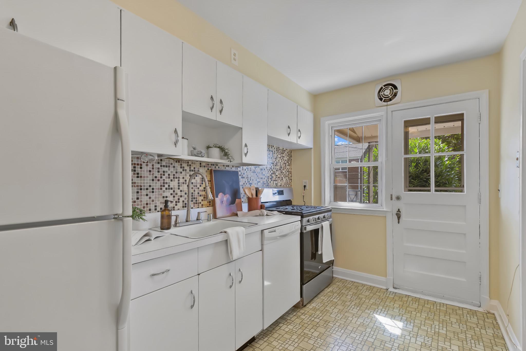 101 Regester Avenue Baltimore, MD 21212 - Photo 12 of 53 a kitchen with white cabinets and sink