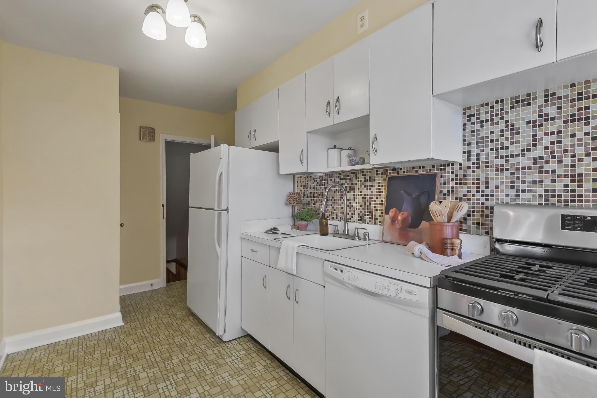 101 Regester Avenue Baltimore, MD 21212 - Photo 13 of 53 a kitchen with a stove and a refrigerator