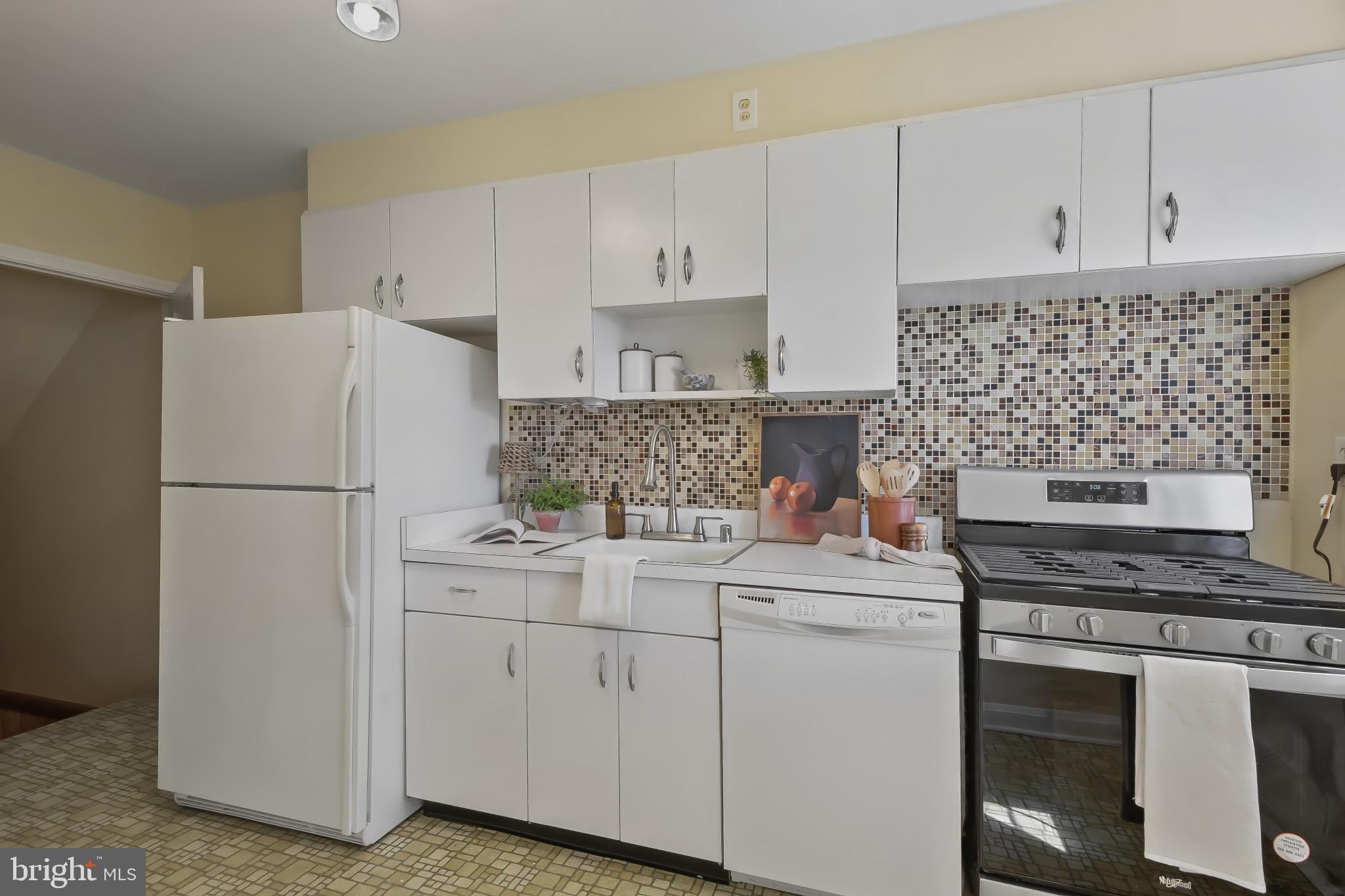 101 Regester Avenue Baltimore, MD 21212 - Photo 14 of 53 a kitchen with appliances a sink and cabinets