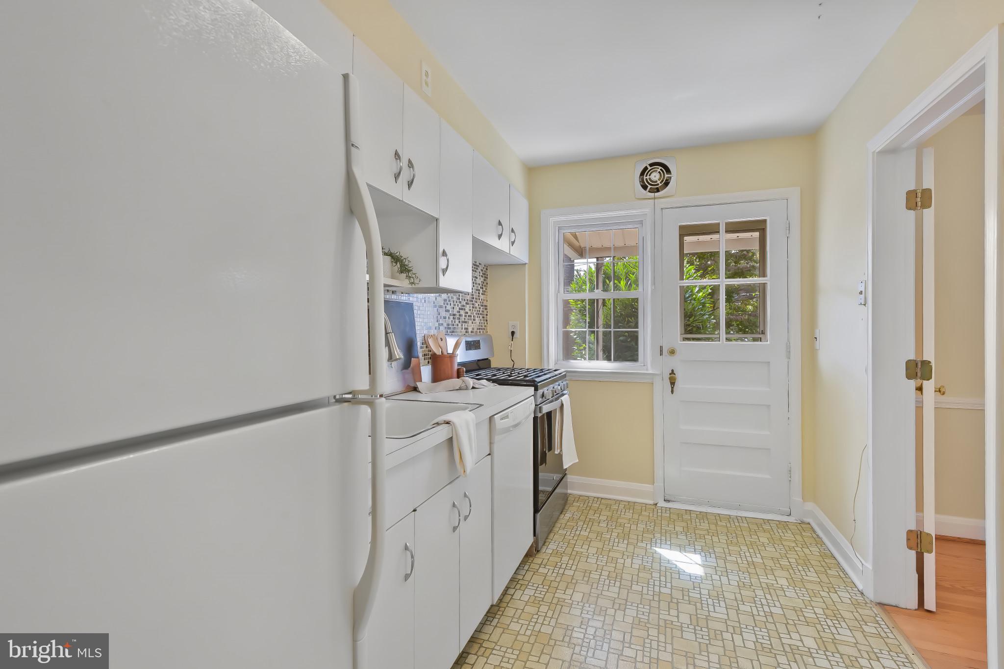 101 Regester Avenue Baltimore, MD 21212 - Photo 15 of 53 a kitchen with white cabinets and white appliances
