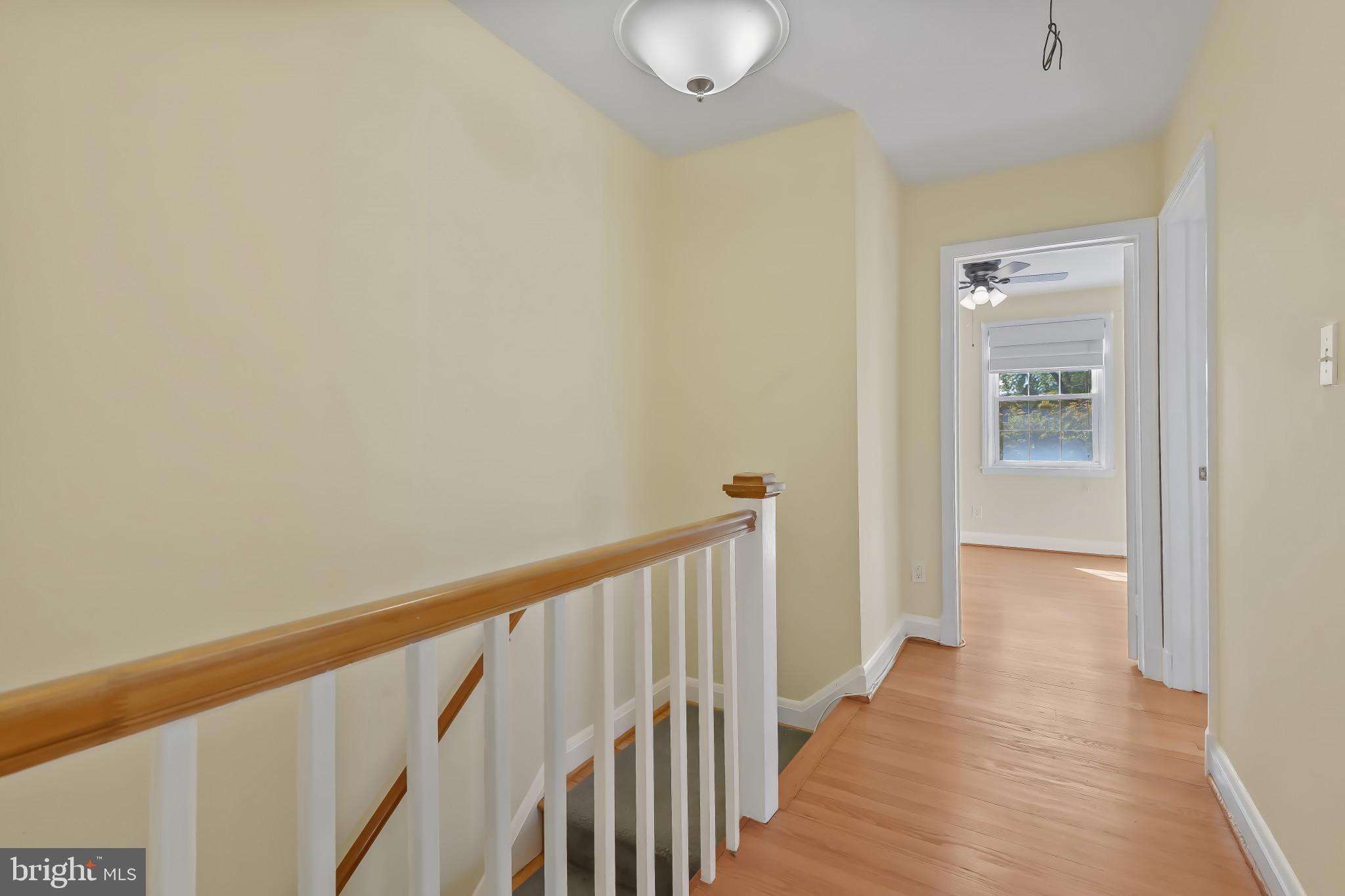 101 Regester Avenue Baltimore, MD 21212 - Photo 26 of 53 a view of a hallway with wooden floor and a bathroom