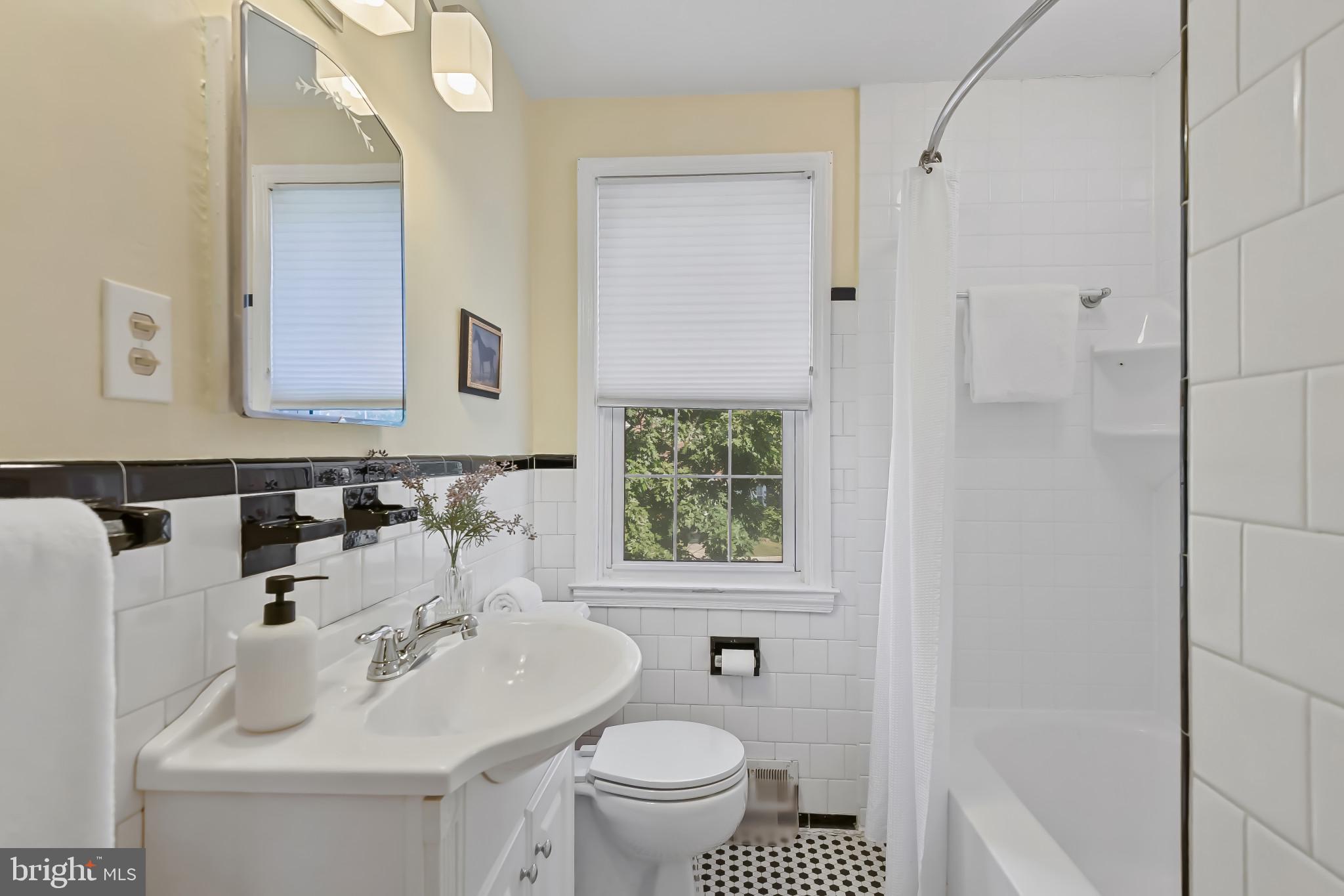 101 Regester Avenue Baltimore, MD 21212 - Photo 27 of 53 a bathroom with a sink toilet and mirror