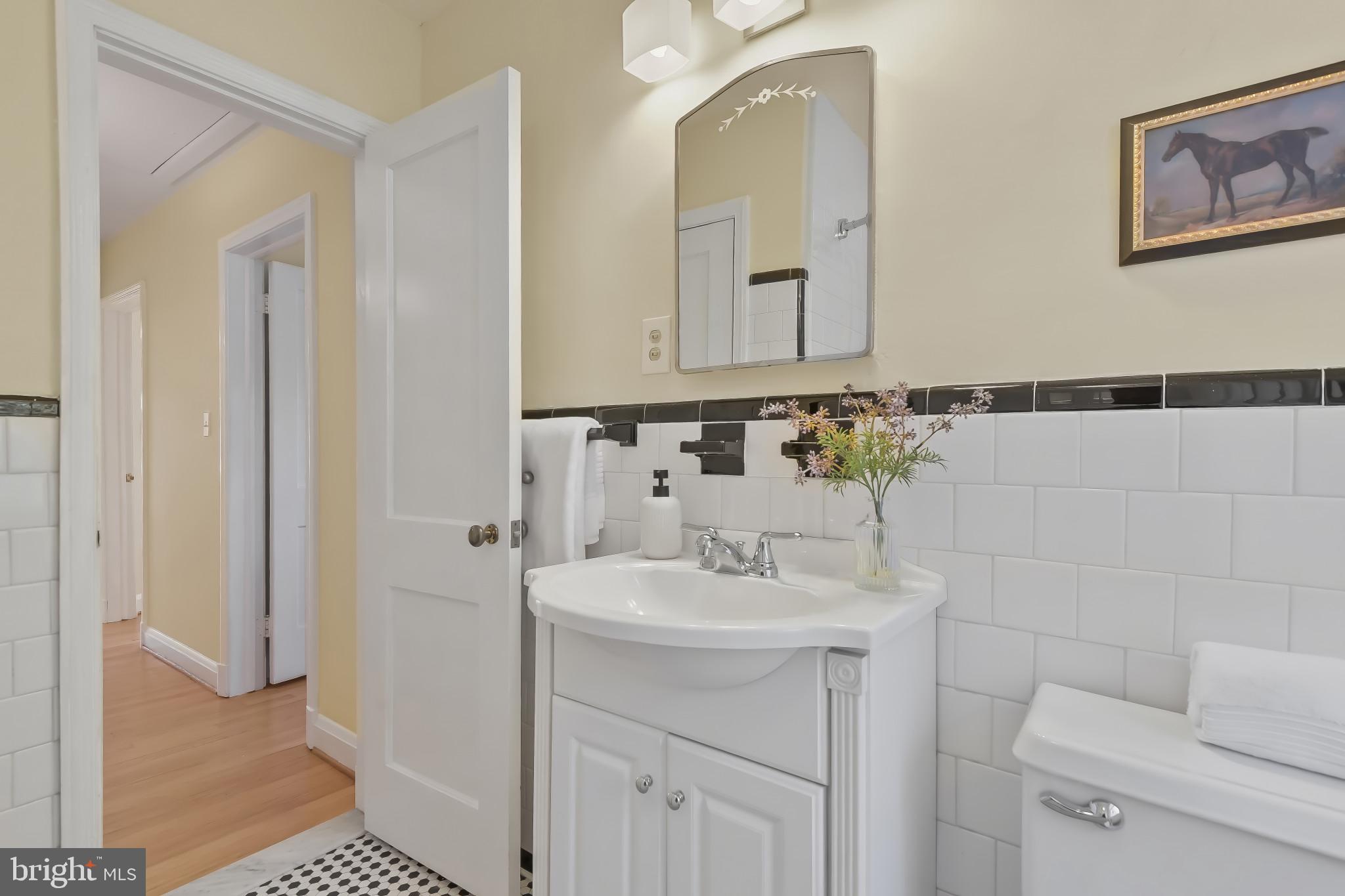 101 Regester Avenue Baltimore, MD 21212 - Photo 29 of 53 a bathroom with a sink toilet and mirror
