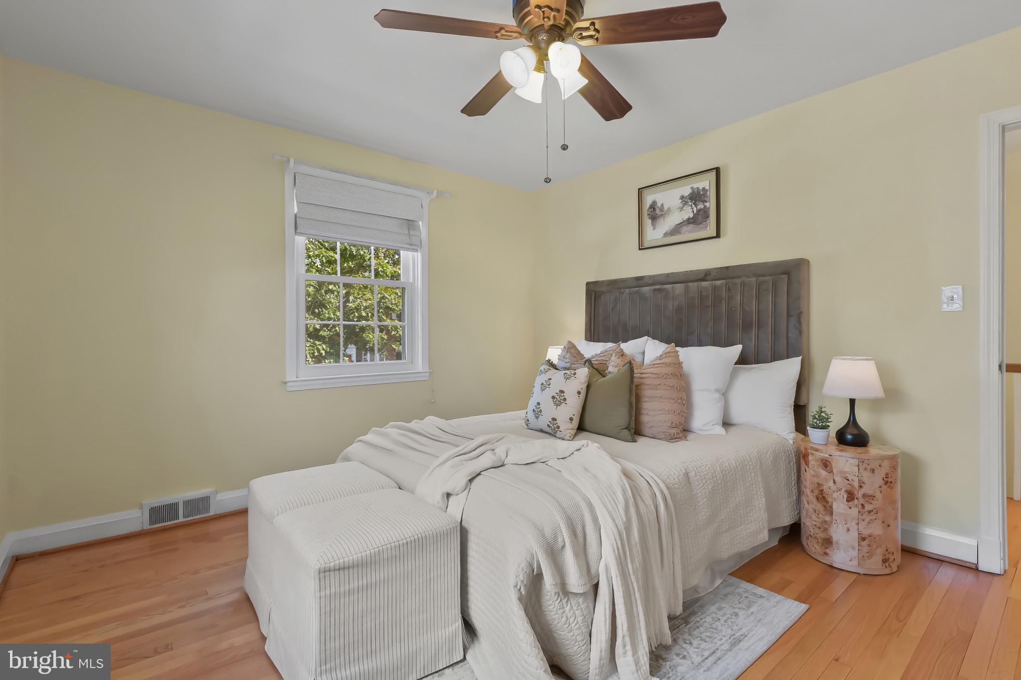 101 Regester Avenue Baltimore, MD 21212 - Photo 31 of 53 a bedroom with a bed and wooden floor