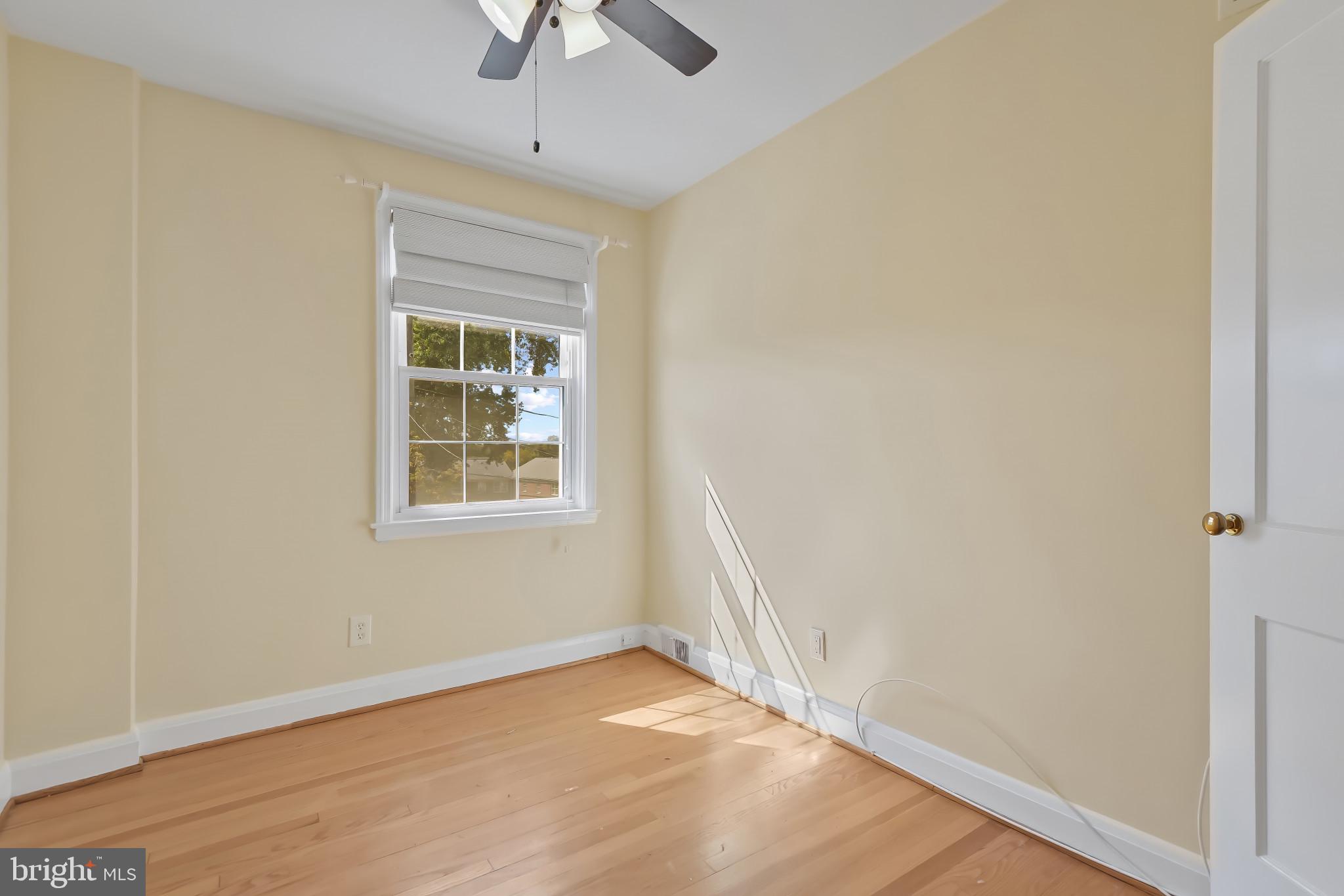 101 Regester Avenue Baltimore, MD 21212 - Photo 41 of 53 a view of an empty room with wooden floor and a window