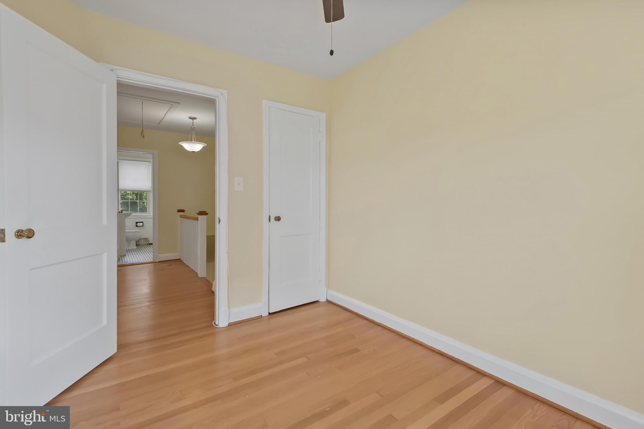 101 Regester Avenue Baltimore, MD 21212 - Photo 42 of 53 a view of an empty room with wooden floor and a bathroom