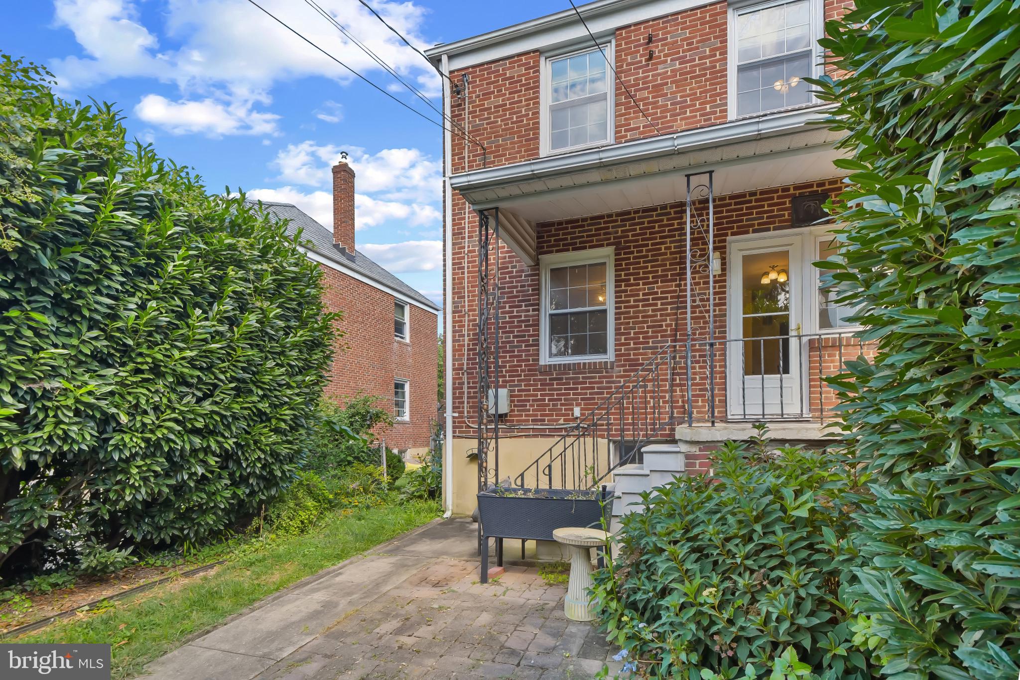 101 Regester Avenue Baltimore, MD 21212 - Photo 47 of 53 a view of a brick house with a yard and plants