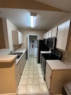 a kitchen with a stove and a refrigerator