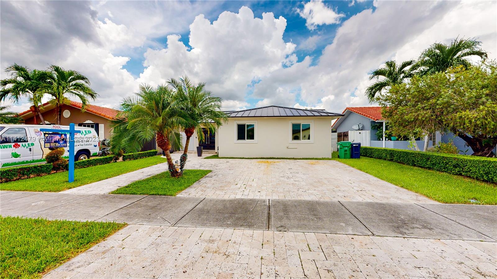 13821 Southwest 14th Street Miami, FL 33184 - Photo 1 of 58 a front view of house with yard and green space