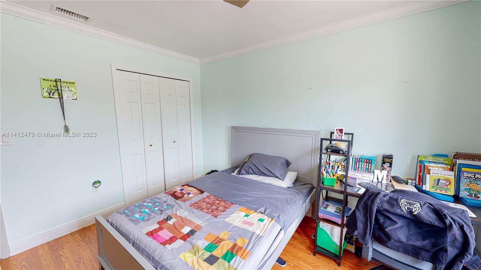 13821 Southwest 14th Street Miami, FL 33184 - Photo 25 of 58 a bedroom with a bed and a book shelf