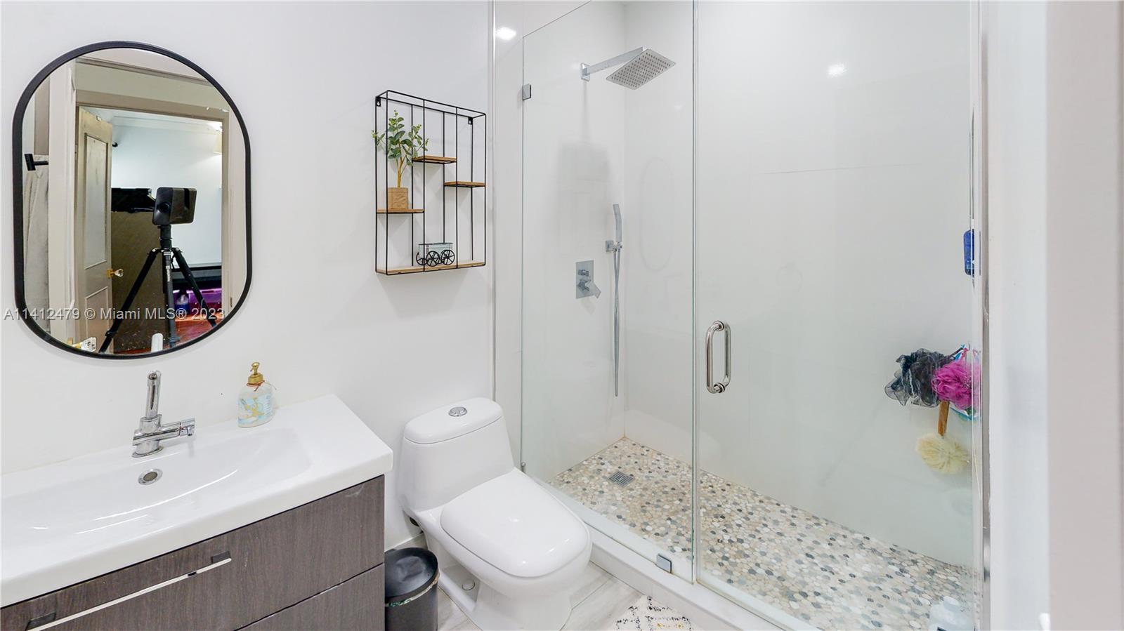13821 Southwest 14th Street Miami, FL 33184 - Photo 26 of 58 a bathroom with a sink a toilet and shower