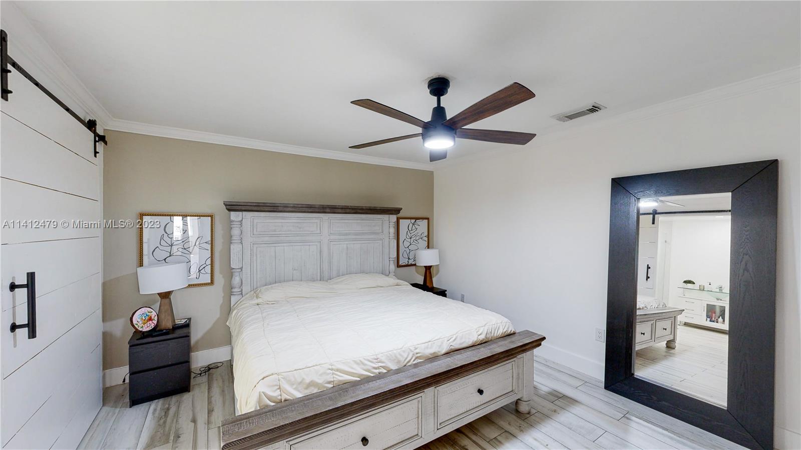 13821 Southwest 14th Street Miami, FL 33184 - Photo 33 of 58 a bedroom with a large bed and a chandelier