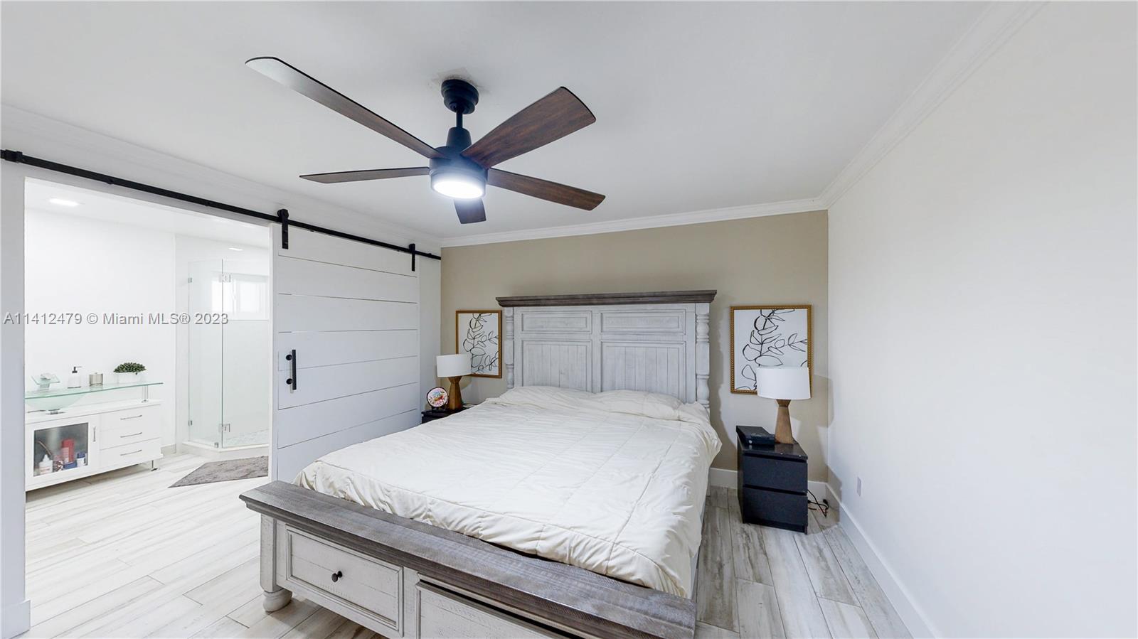 13821 Southwest 14th Street Miami, FL 33184 - Photo 35 of 58 a bedroom with a bed and a ceiling fan