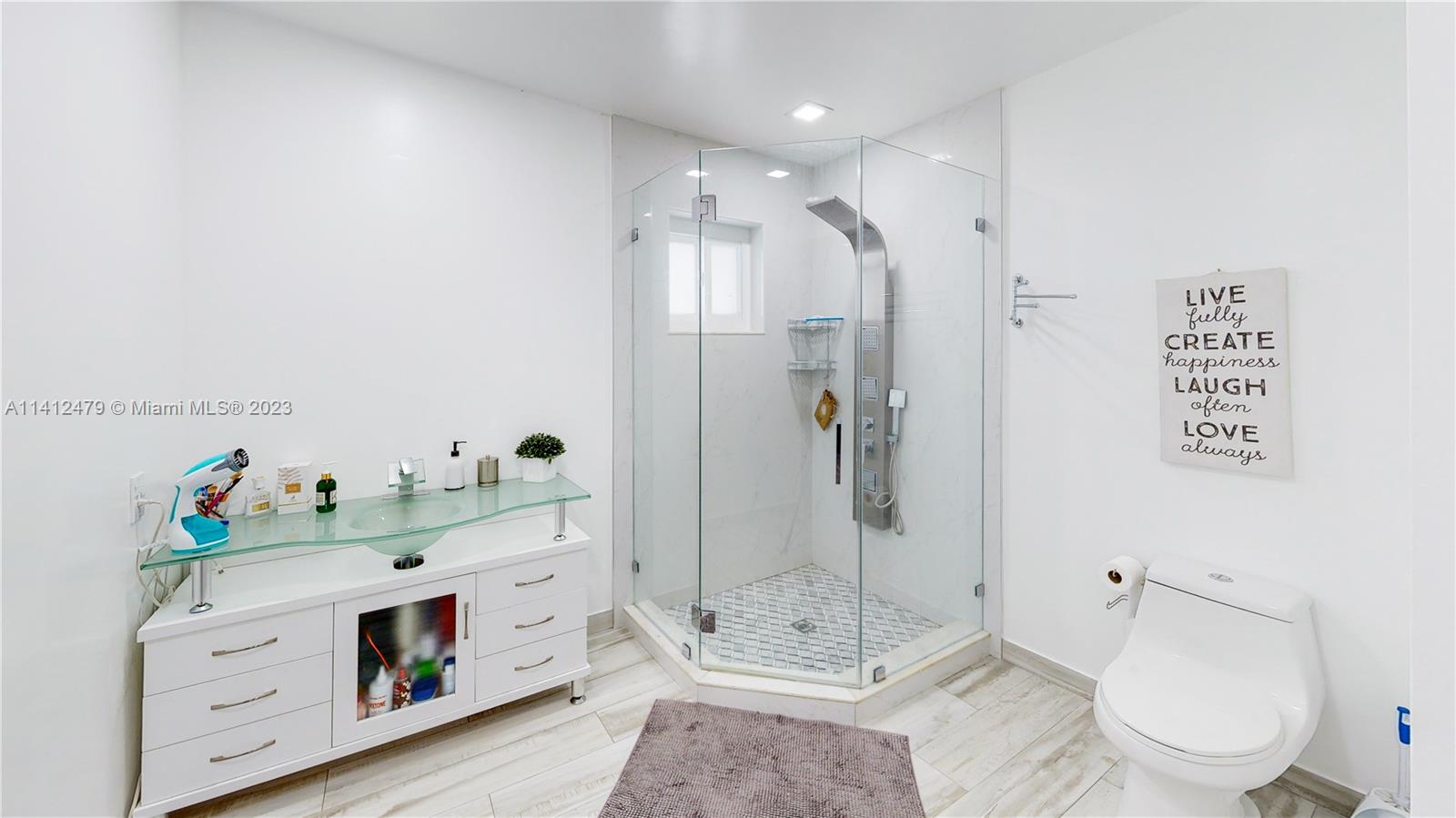 13821 Southwest 14th Street Miami, FL 33184 - Photo 36 of 58 a bathroom with a sink toilet and shower