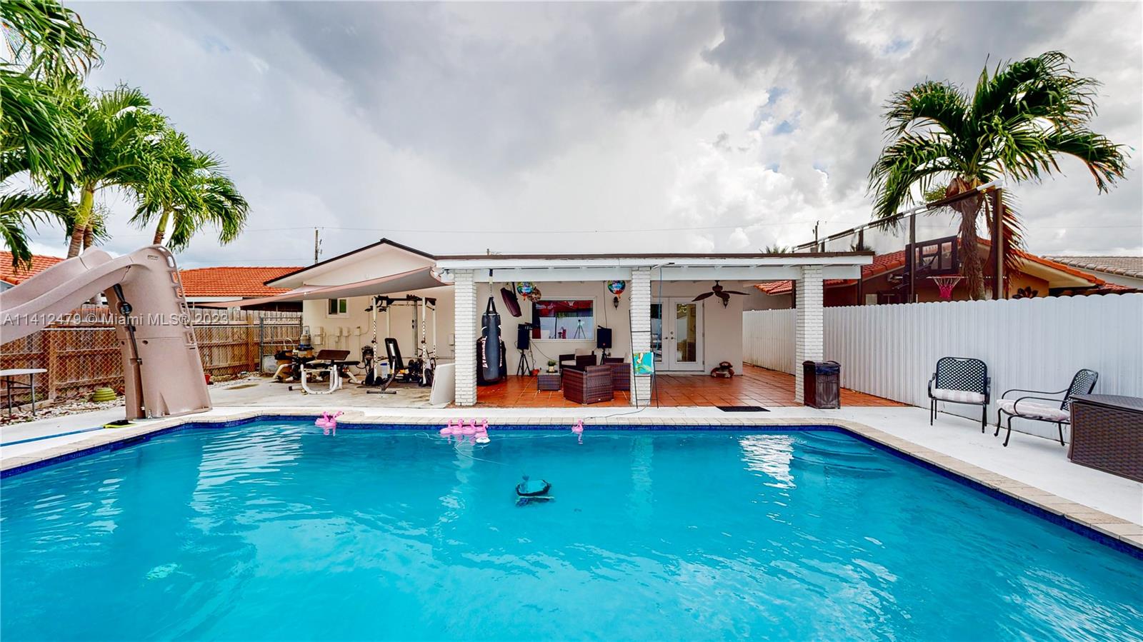 13821 Southwest 14th Street Miami, FL 33184 - Photo 41 of 58 an outdoor space view of house with swimming pool and furniture