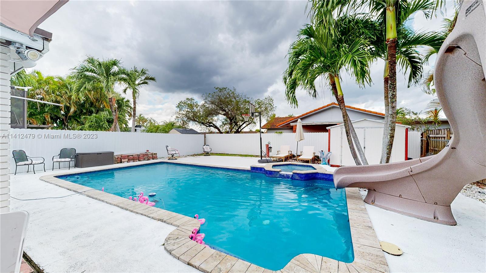 13821 Southwest 14th Street Miami, FL 33184 - Photo 45 of 58 a view of swimming pool with a table and chairs