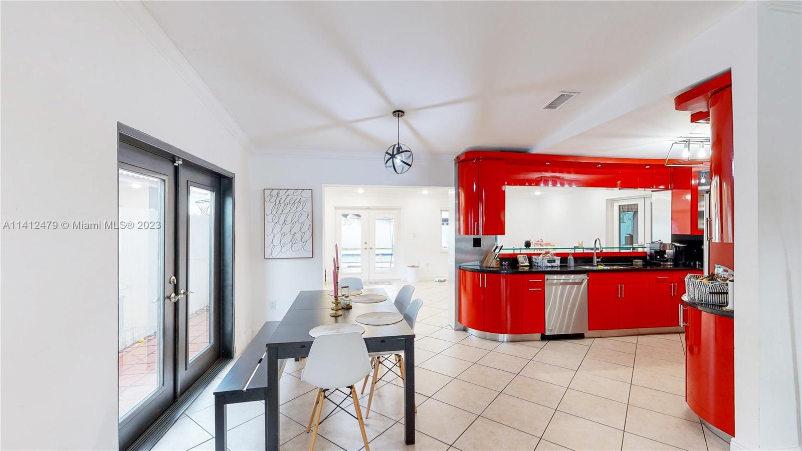 13821 Southwest 14th Street Miami, FL 33184 - Photo 10 of 58 a kitchen with stainless steel appliances kitchen island granite countertop a refrigerator and a stove