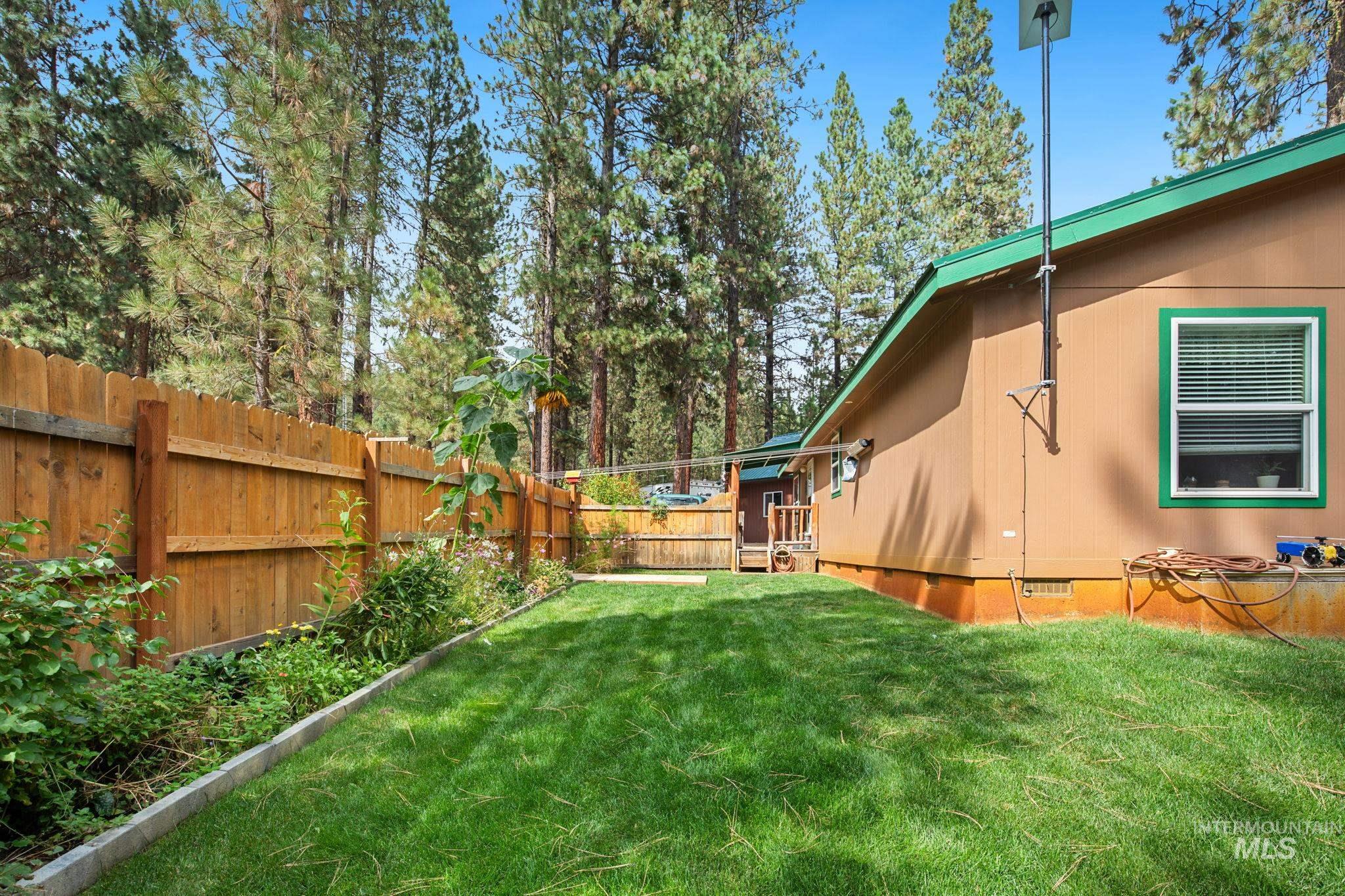 10 Cricket Road Garden Valley, ID 83622 - Photo 20 of 50 Fenced backyard with view of wooded area