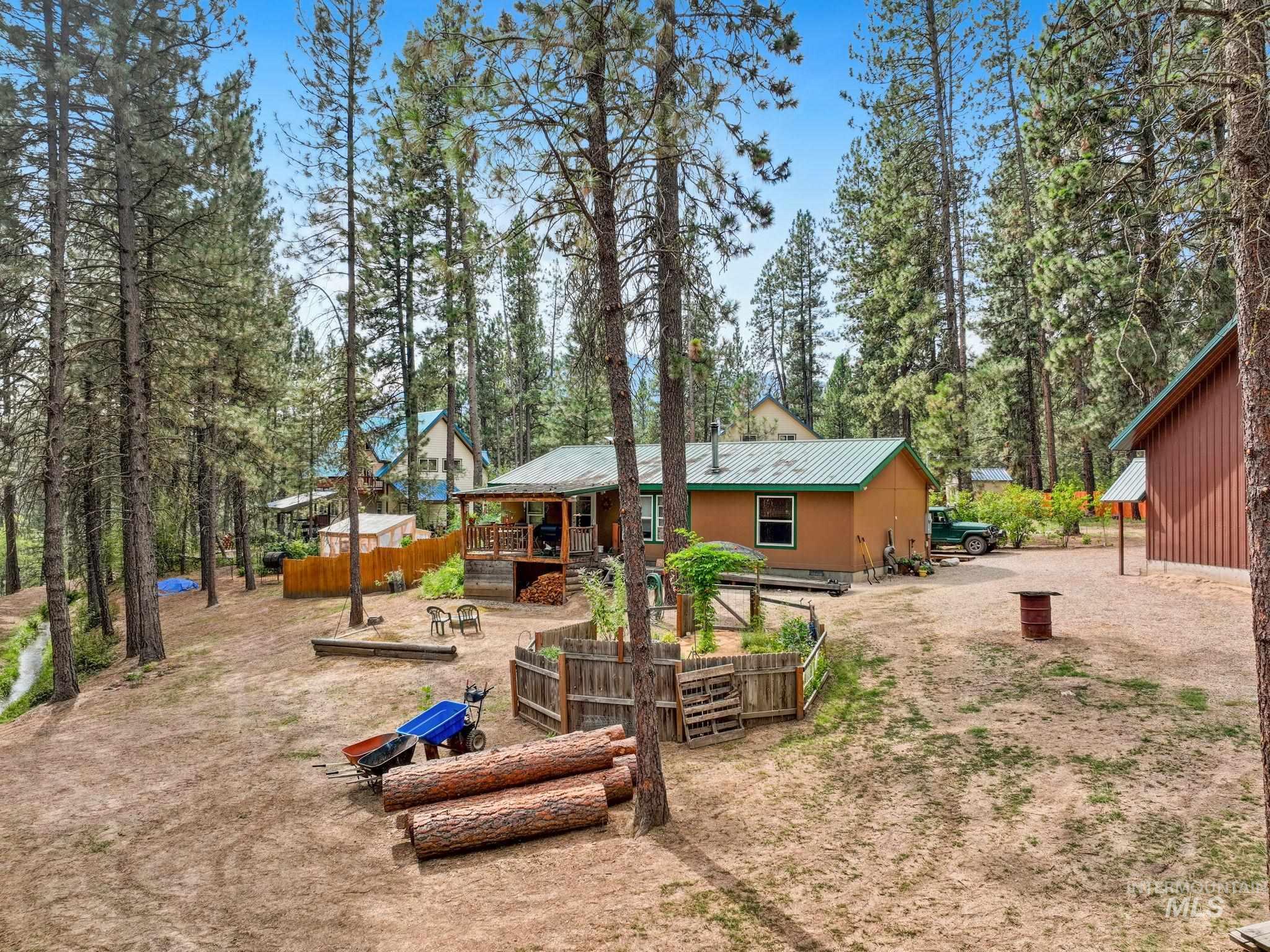 10 Cricket Road Garden Valley, ID 83622 - Photo 5 of 50 Rear view of property with a metal roof and a wooden deck