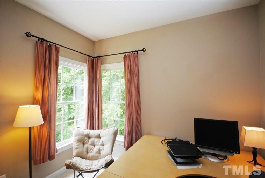 8805 Braceridge Road Raleigh, NC 27613 - Photo 13 of 25 a bedroom with a bed and a flat screen tv