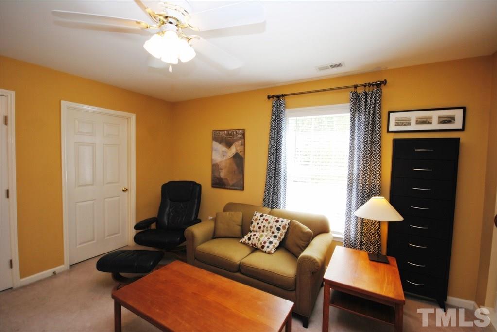 8805 Braceridge Road Raleigh, NC 27613 - Photo 15 of 25 a living room with furniture and a lamp