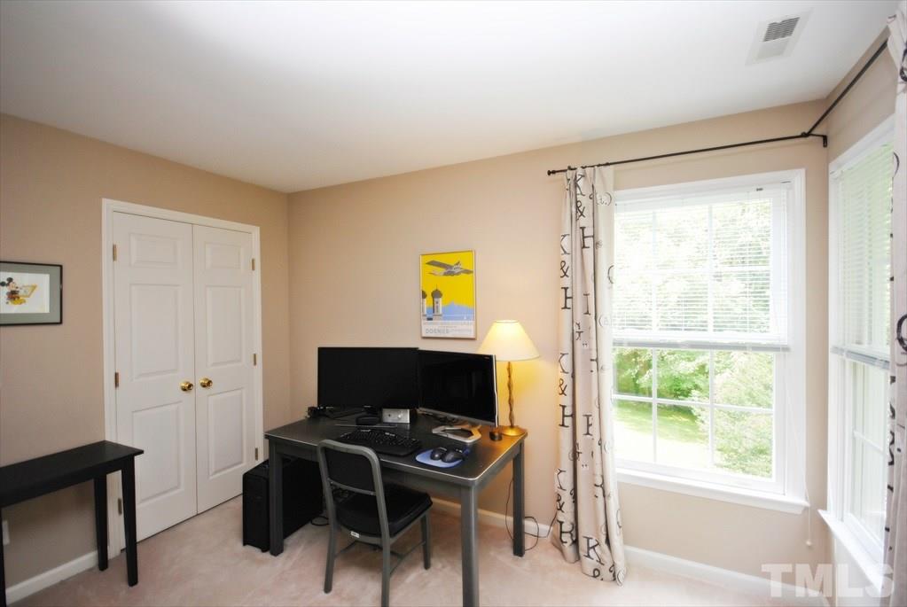 8805 Braceridge Road Raleigh, NC 27613 - Photo 17 of 25 a view of a workspace with furniture and a window
