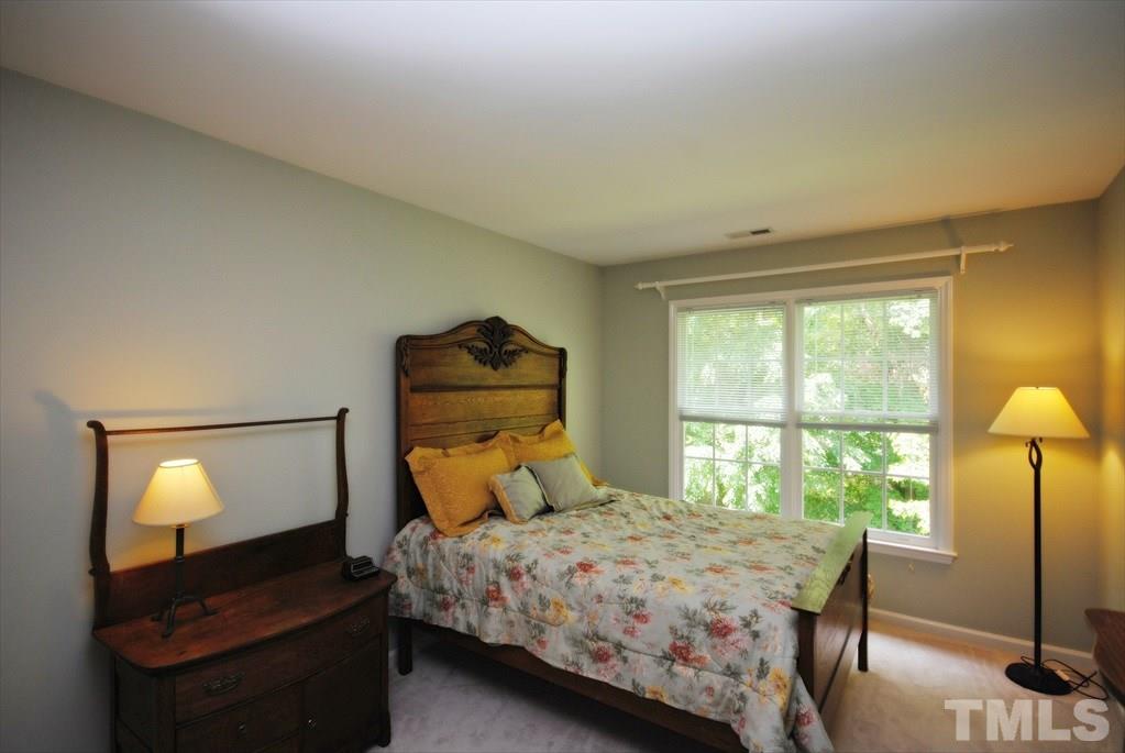 8805 Braceridge Road Raleigh, NC 27613 - Photo 19 of 25 a bedroom with a bed and a window