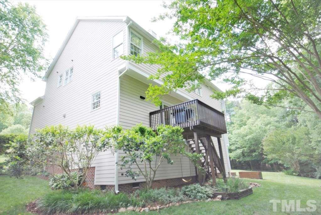 8805 Braceridge Road Raleigh, NC 27613 - Photo 23 of 25 a view of a house with a yard and plants