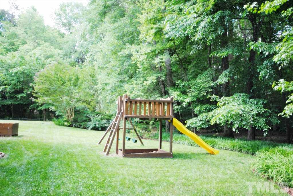8805 Braceridge Road Raleigh, NC 27613 - Photo 25 of 25 a view of playground with a slide and swing