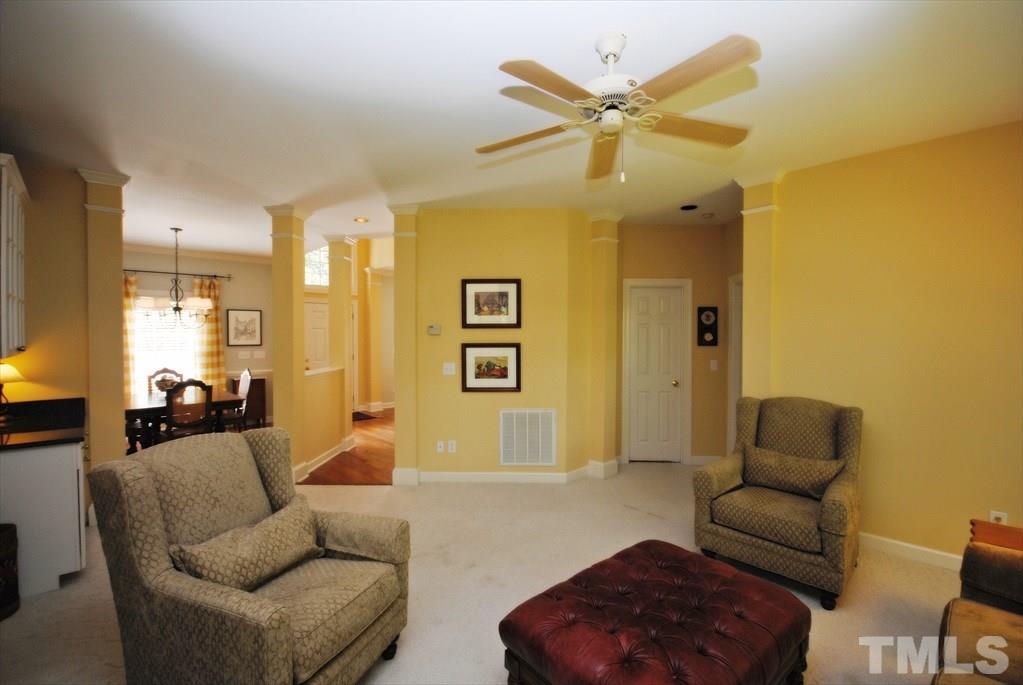 8805 Braceridge Road Raleigh, NC 27613 - Photo 9 of 25 a living room with furniture and a chandelier