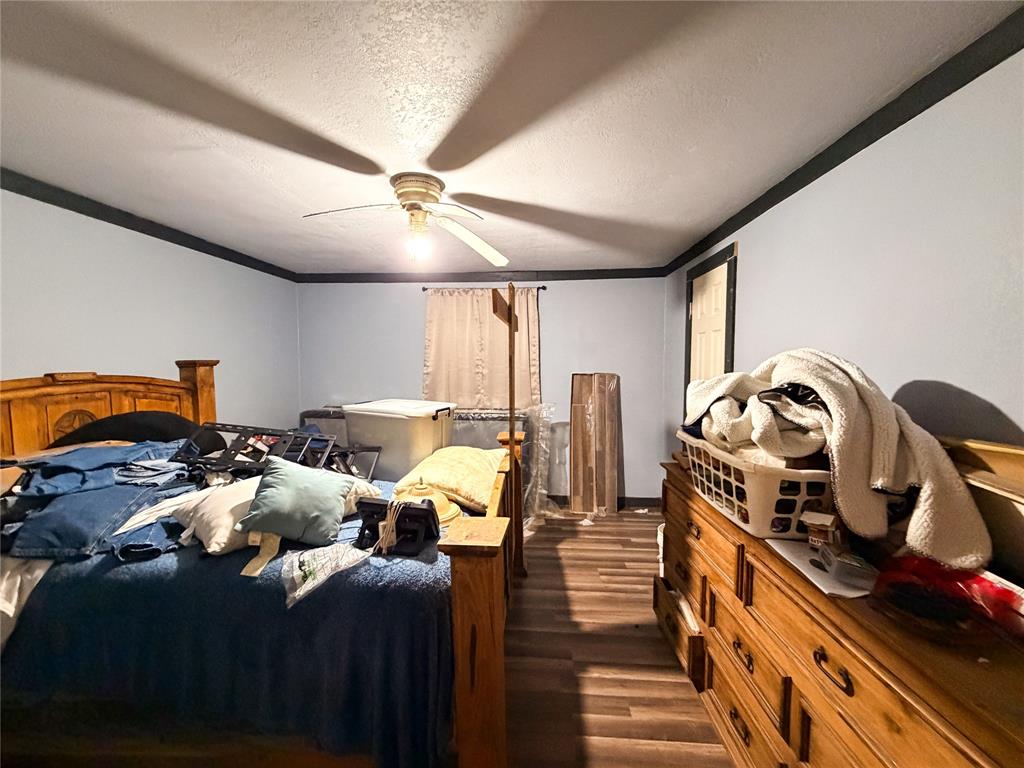 506 North Ave B Haskell, TX 79521 - Photo 8 of 13 a bedroom with furniture and a wooden floor