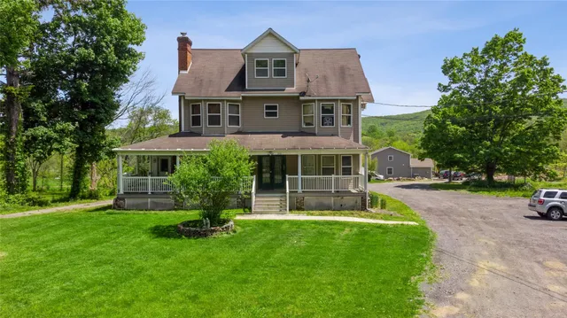 a front view of house with yard and green space
