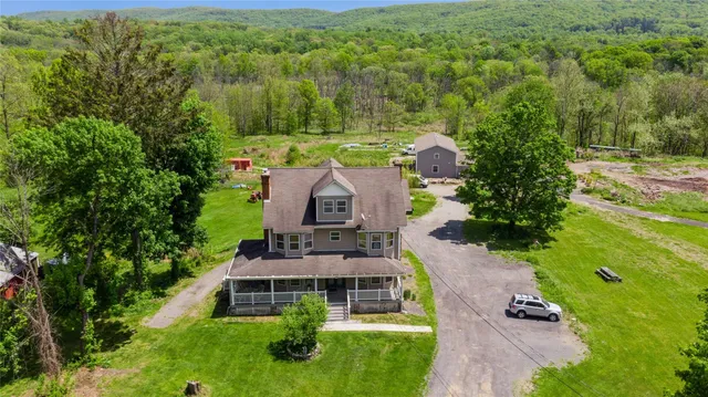 an aerial view of a house with yard swimming pool and outdoor seating