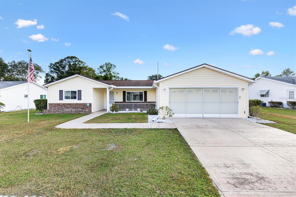 a view of a house with a yard and a garage