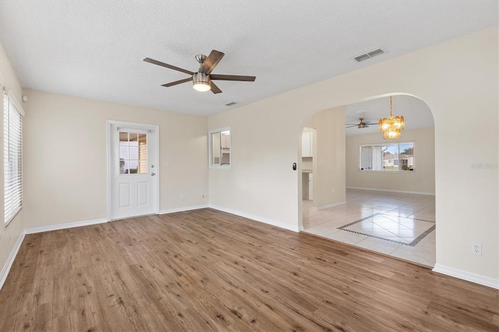 10767 Southeast 174th Loop Summerfield, FL 34491 - Photo 16 of 45 wooden floor in an empty room with a window