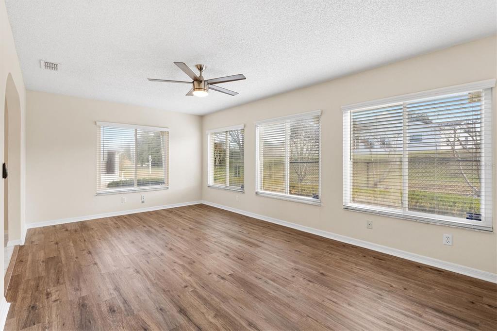 10767 Southeast 174th Loop Summerfield, FL 34491 - Photo 18 of 45 a view of an empty room with wooden floor and a window