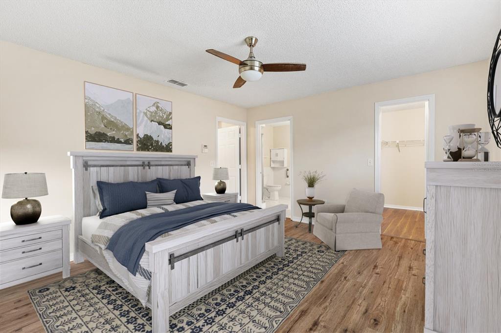 10767 Southeast 174th Loop Summerfield, FL 34491 - Photo 19 of 45 a bedroom with a bed and a couch