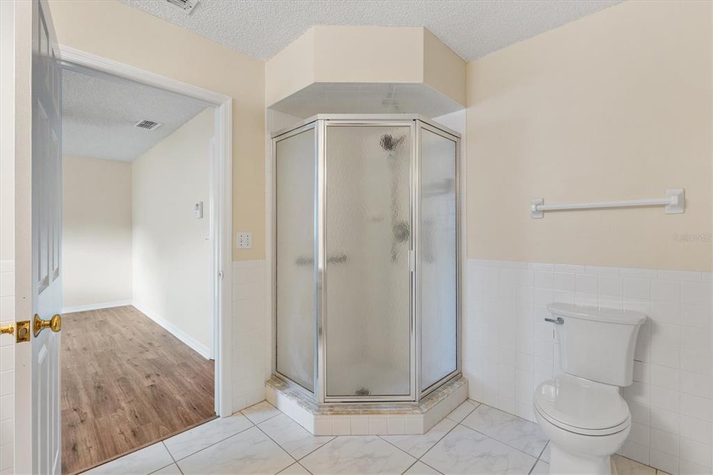 10767 Southeast 174th Loop Summerfield, FL 34491 - Photo 23 of 45 a bathroom with a granite countertop shower and a toilet
