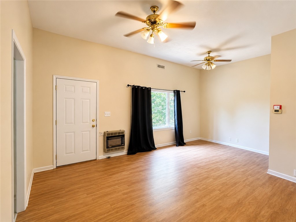 597 Old Hurricane Road Westminster, SC 29693 - Photo 4 of 11 A welcoming interior with warm wood flooring and overhead ceiling fans.