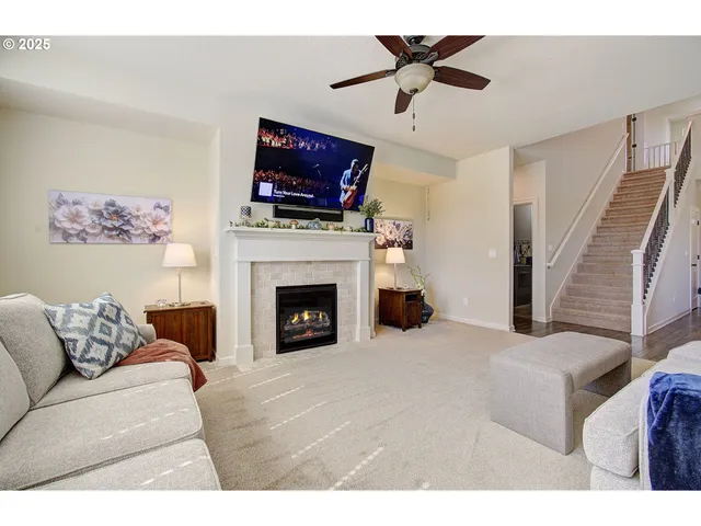 a living room with furniture and a ceiling fan