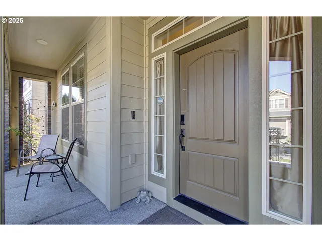 a hallway with a wooden floor and a dining table