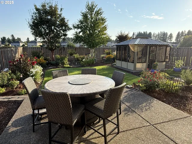 a dining room with furniture a chandelier and wooden floor