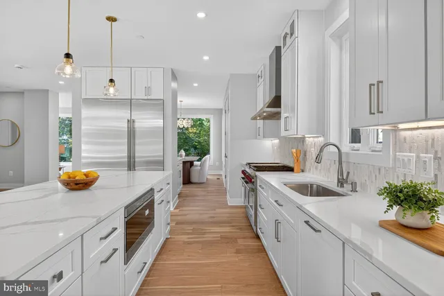 a kitchen with a sink appliances and cabinets