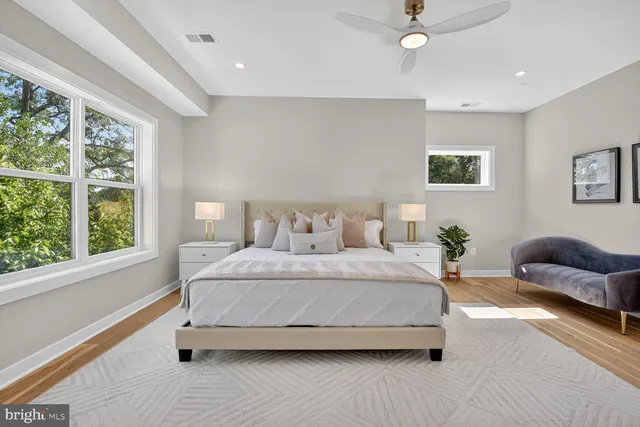 a spacious bedroom with a bed and a couch