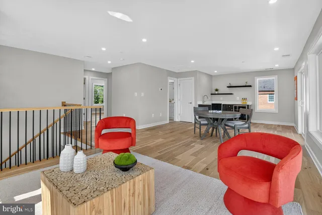 a kitchen with stainless steel appliances granite countertop a stove a sink and a refrigerator with wooden floors