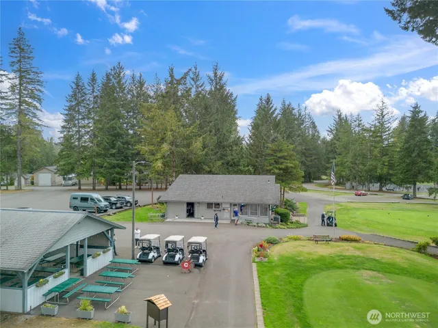 a view of an house with backyard space and sitting area