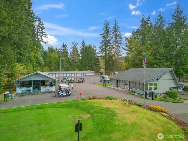 a view of a house with swimming pool and sitting area