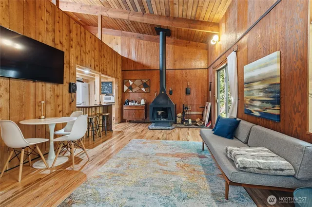 a view of a patio with couches table and chairs with wooden floor