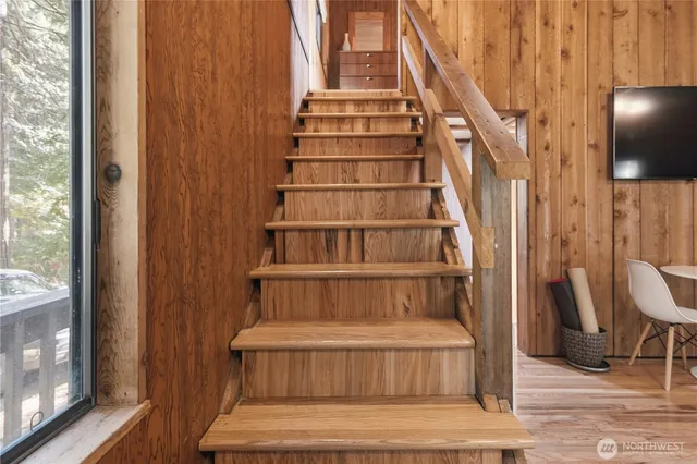 a view of staircase with white walls and a window