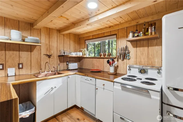a kitchen with a sink cabinets and window